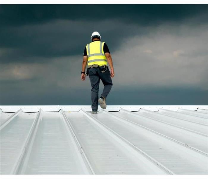 Construction engineer uniform safety dress safety inspection of metal roofing for industrial roofing concept with copy space.